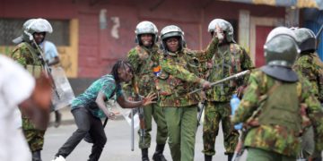 FILE - Police clash with a man during a protest by supporters of Kenya's opposition leader Raila Odinga over the high cost of living and alleged stolen presidential vote, in Nairobi, on March 20, 2023. The United States is praising Kenya's interest in leading a multinational force in Haiti. But weeks ago, the U.S. openly warned Kenyan police officers against violent abuses. Now 1,000 of those police officers might head to Haiti to take on gang warfare. (AP Photo/Brian Inganga, File)