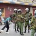 FILE - Police clash with a man during a protest by supporters of Kenya's opposition leader Raila Odinga over the high cost of living and alleged stolen presidential vote, in Nairobi, on March 20, 2023. The United States is praising Kenya's interest in leading a multinational force in Haiti. But weeks ago, the U.S. openly warned Kenyan police officers against violent abuses. Now 1,000 of those police officers might head to Haiti to take on gang warfare. (AP Photo/Brian Inganga, File)